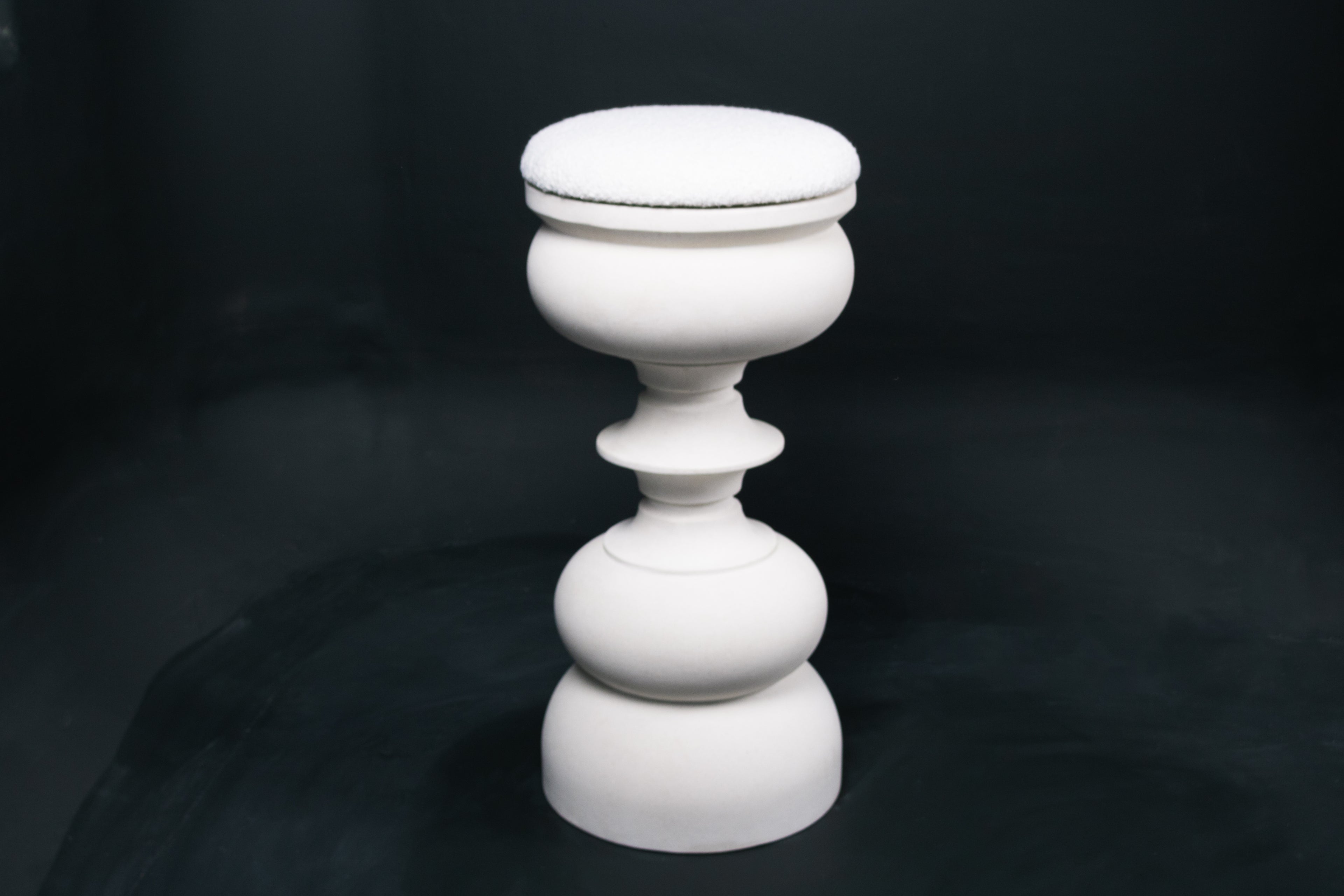 Baluster barstool in white. The base stacks three softly rounded bulbous forms. A broad domed foot, a mid sphere, and an upper globe, connected by a narrow collar, and topped with a wide disc and round white bouclé upholstered seat.