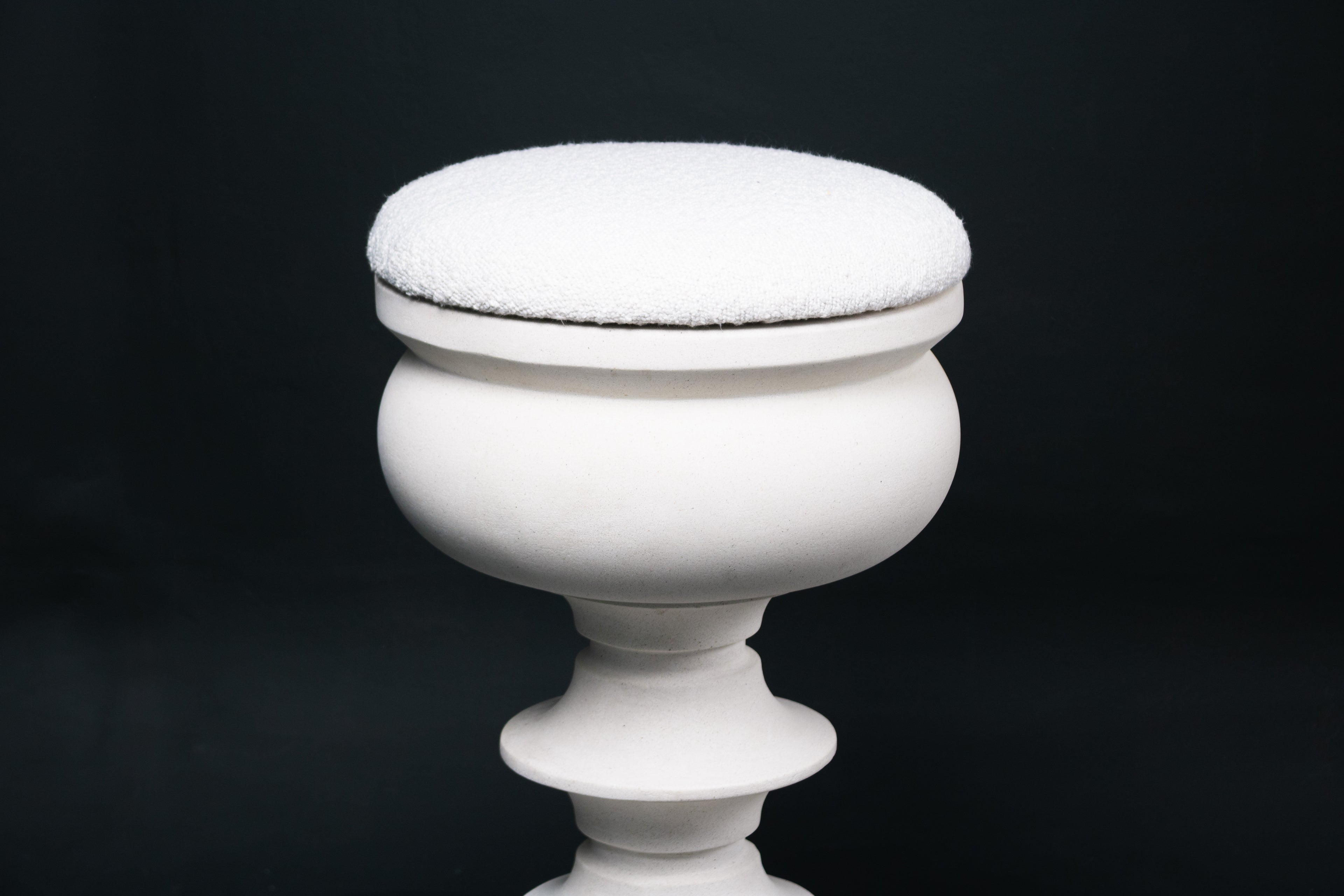 Baluster barstool in white. The base stacks three softly rounded bulbous forms. A broad domed foot, a mid sphere, and an upper globe, connected by a narrow collar, and topped with a wide disc and round white bouclé upholstered seat.
