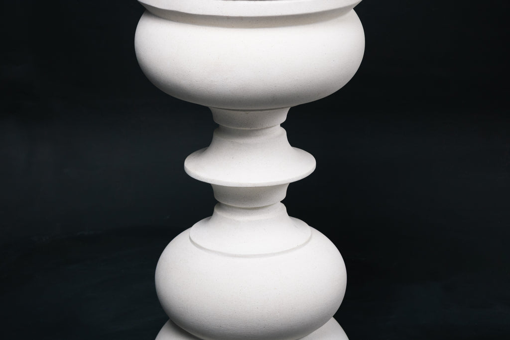 Baluster barstool in white. The base stacks three softly rounded bulbous forms. A broad domed foot, a mid sphere, and an upper globe, connected by a narrow collar, and topped with a wide disc and round white bouclé upholstered seat.