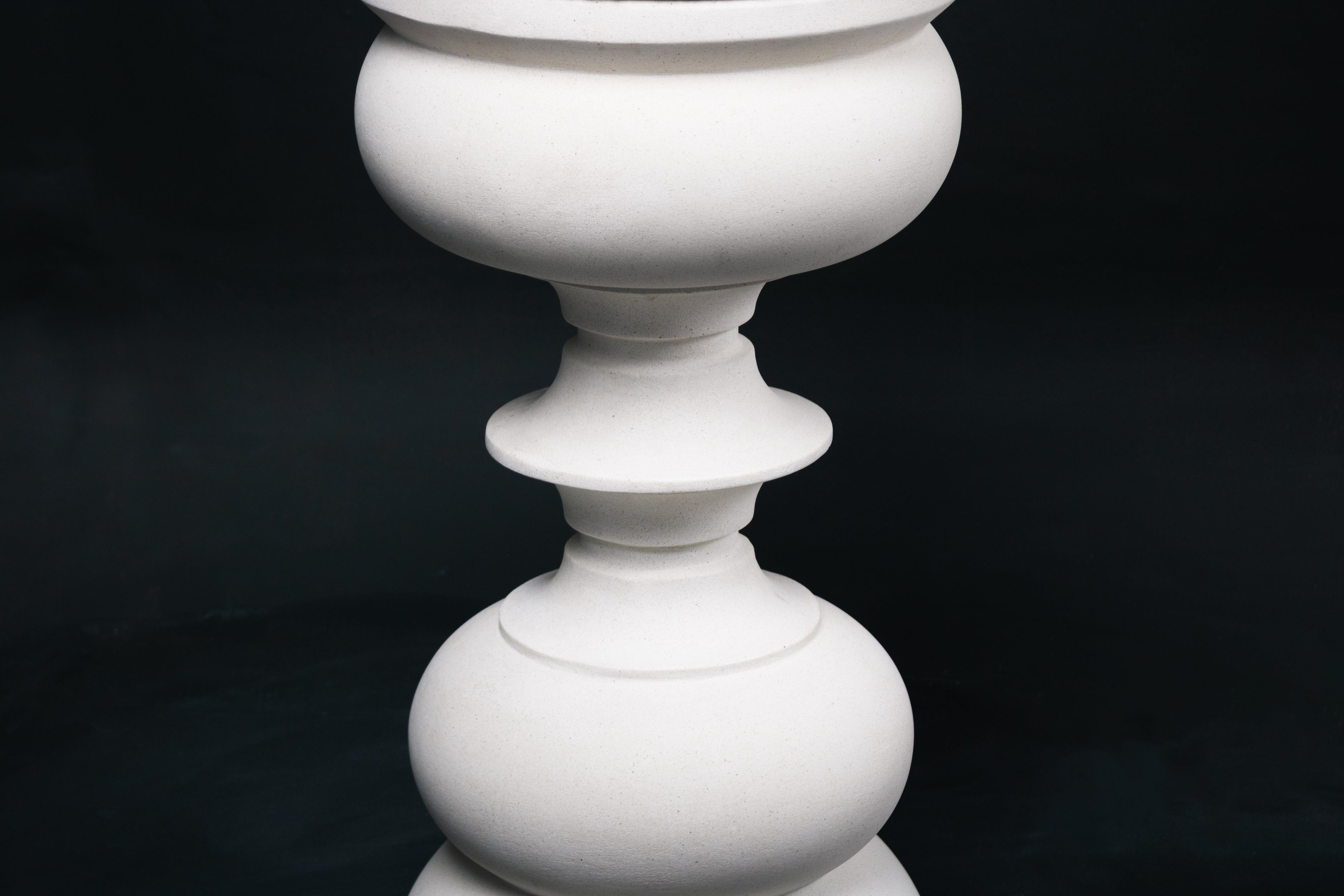 Baluster barstool in white. The base stacks three softly rounded bulbous forms. A broad domed foot, a mid sphere, and an upper globe, connected by a narrow collar, and topped with a wide disc and round white bouclé upholstered seat.