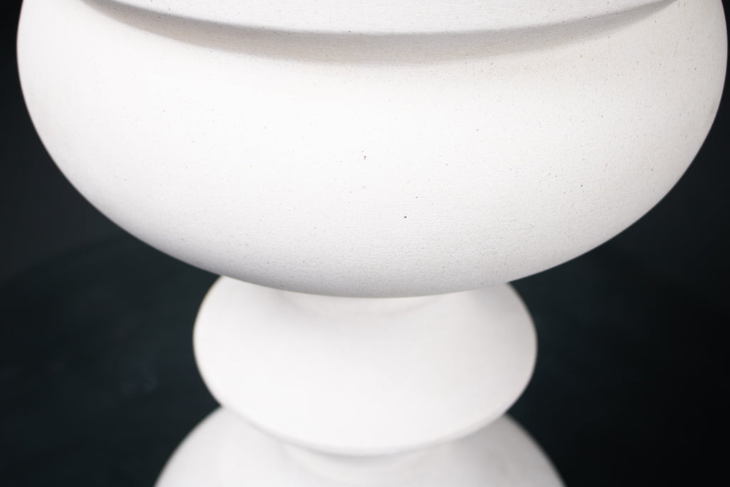 Baluster barstool in white. The base stacks three softly rounded bulbous forms. A broad domed foot, a mid sphere, and an upper globe, connected by a narrow collar, and topped with a wide disc and round white bouclé upholstered seat.