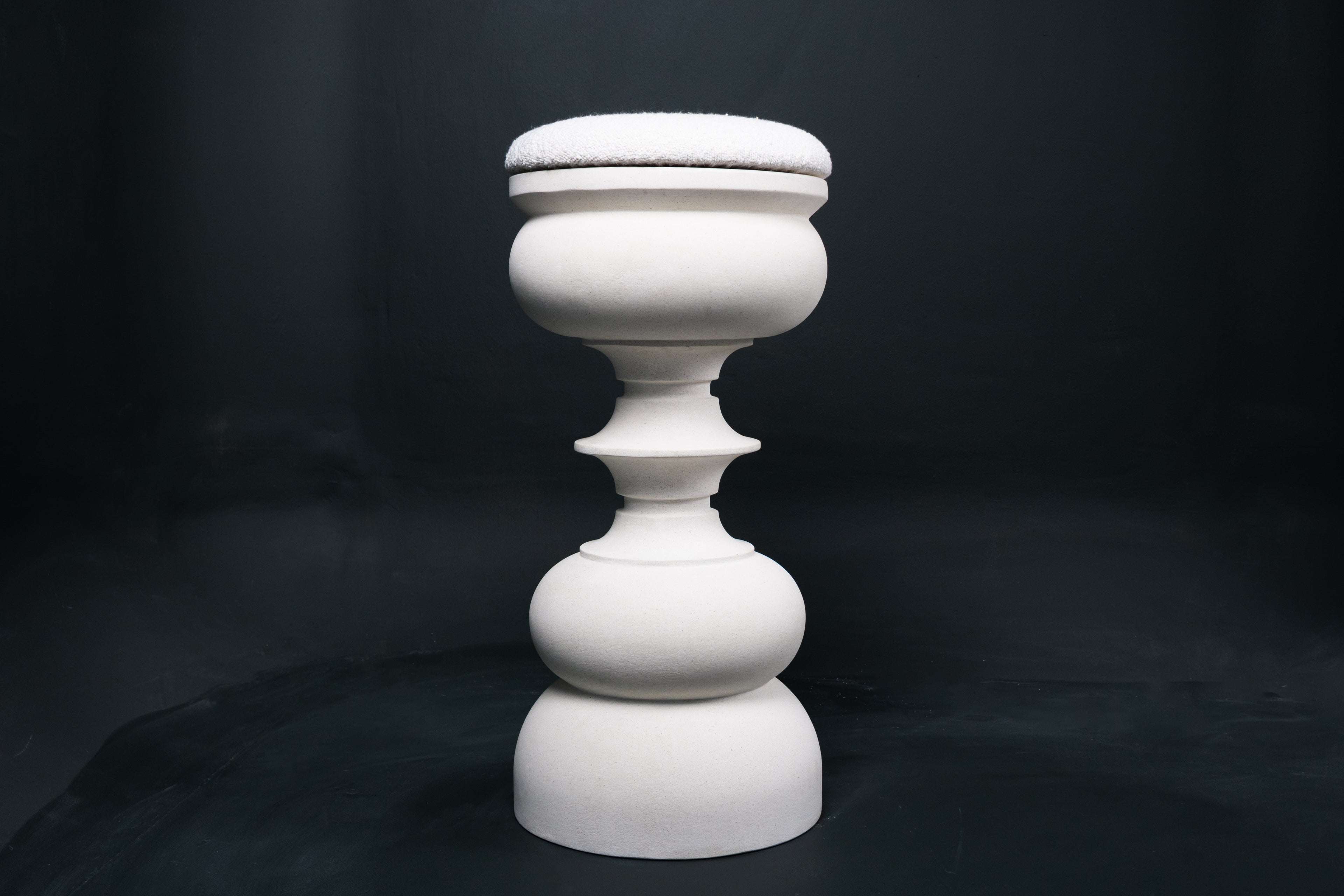 Baluster barstool in white. The base stacks three softly rounded bulbous forms. A broad domed foot, a mid sphere, and an upper globe, connected by a narrow collar, and topped with a wide disc and round white bouclé upholstered seat.