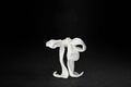 A white plaster sculpture depicting a loosely tied bow. The ribbon forms billow and curl freely, capturing the movement and drape of fabric frozen mid-gesture, with trailing ends pooling at the base.