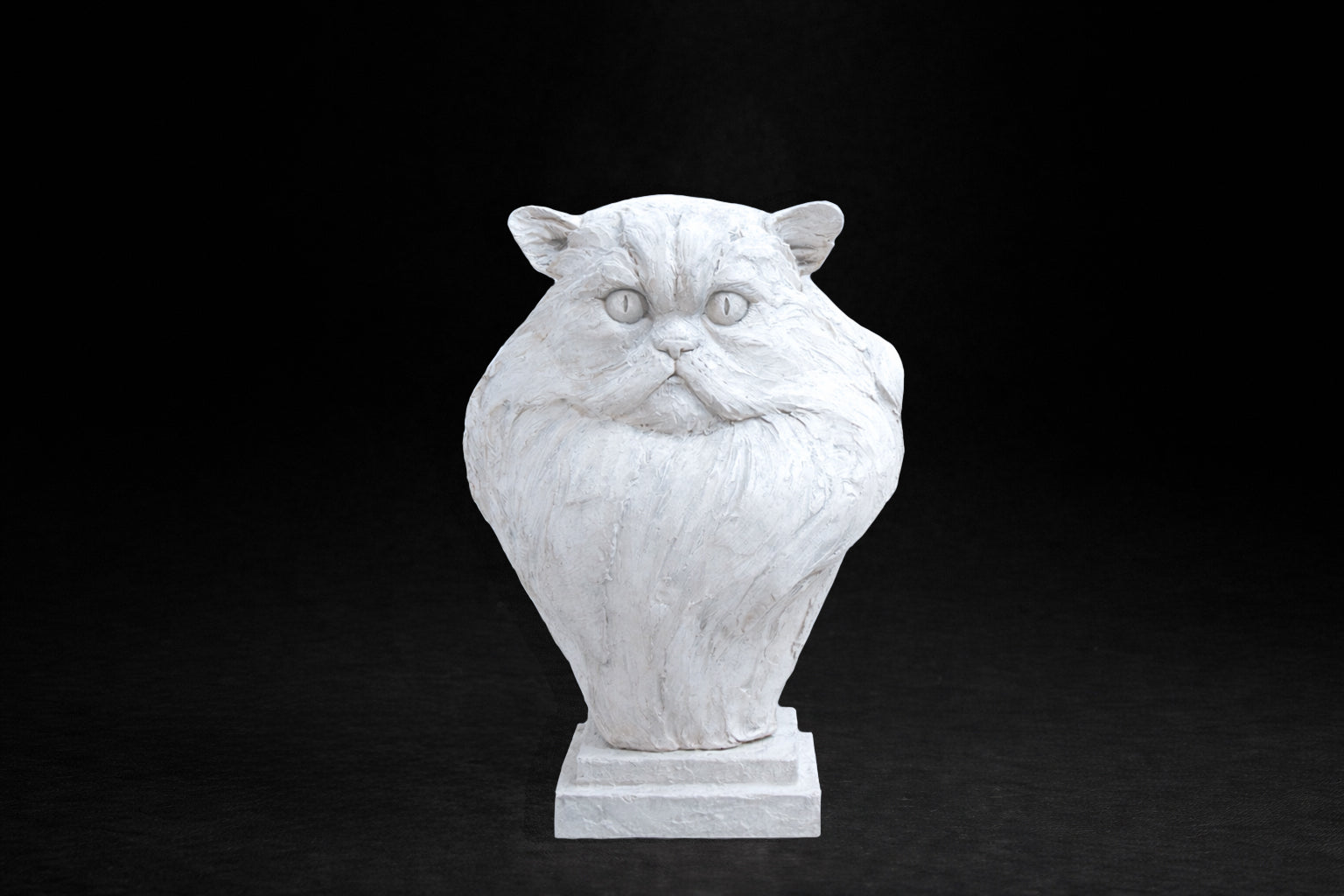 White plaster portrait bust of a Persian cat with a flat face and full fluffy coat on a stepped square stand.