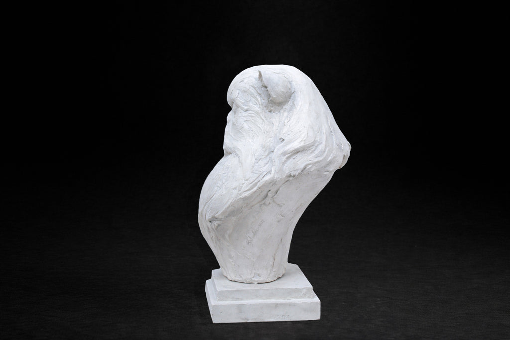 White plaster portrait bust of a Persian cat with a flat face and full fluffy coat on a stepped square stand.