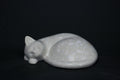The Curly Cat terrazzo doorstop. A close-up view reveals the smoothly cast sleeping cat form, head resting on tucked paws, eyes closed, body curled into a low rounded mass. The pale grey terrazzo surface is flecked with irregular fragments of white and blush quartz.