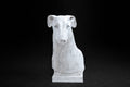 White plaster portrait bust of a Greyhound with a long narrow muzzle on a stepped square base