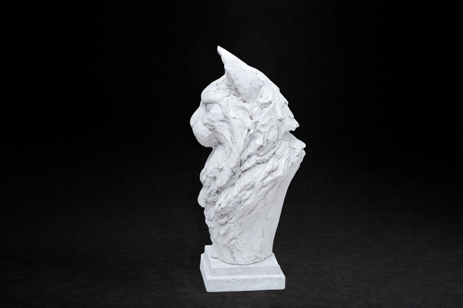 White plaster portrait bust of a Maine Coon cat with a full ruff and tufted ears on a stepped square base.