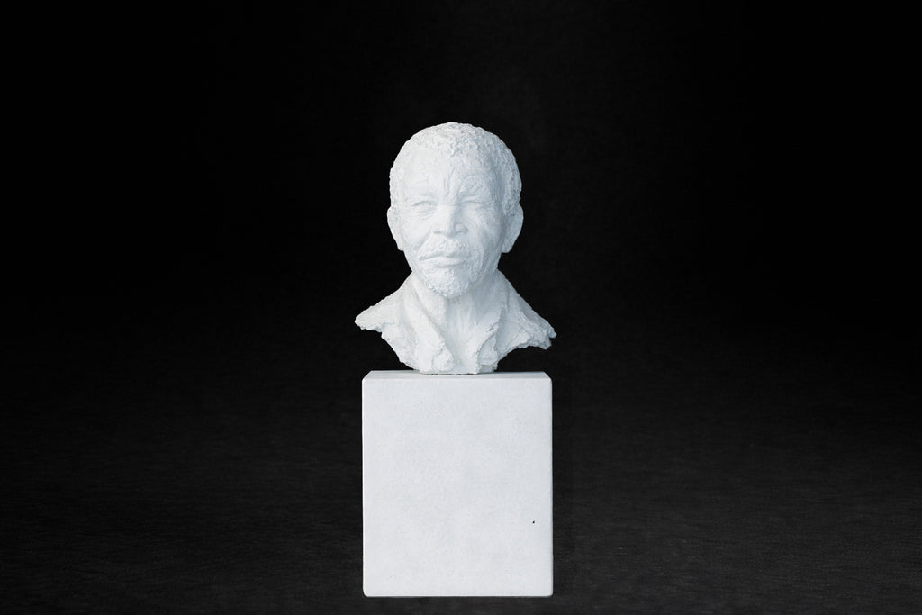 White plaster portrait bust of an elderly man on a square plinth.