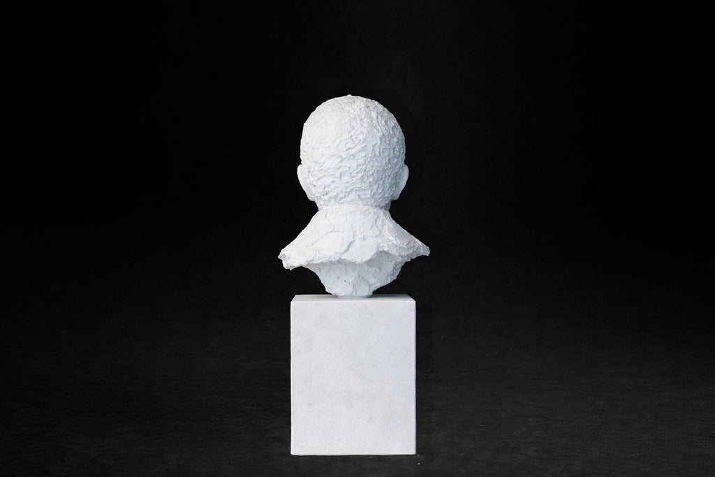 White plaster portrait bust of an elderly man on a square plinth.