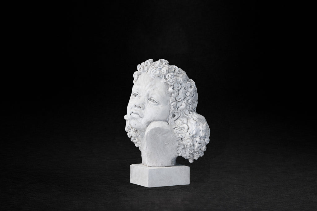 White plaster portrait bust of a young girl with an anguished expression.